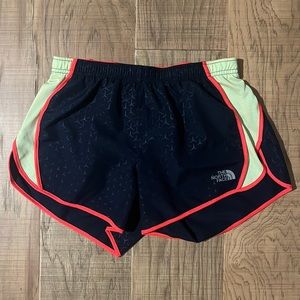 The North Face navy running short with lime green and orange accents